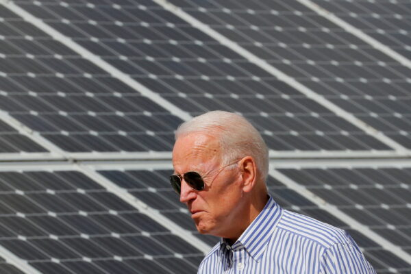 U.S. President Joe Biden walks past solar panels while touring the Plymouth Area Renewable Energy Initiative in Plymouth, New Hampshire, U.S., June 4, 2019. REUTERS/Brian Snyder/File Photo
